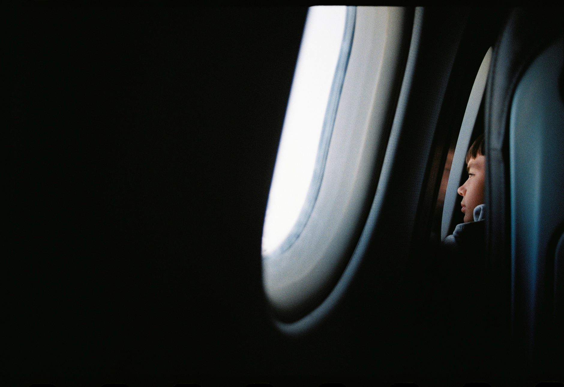 Child sleeping airplane window